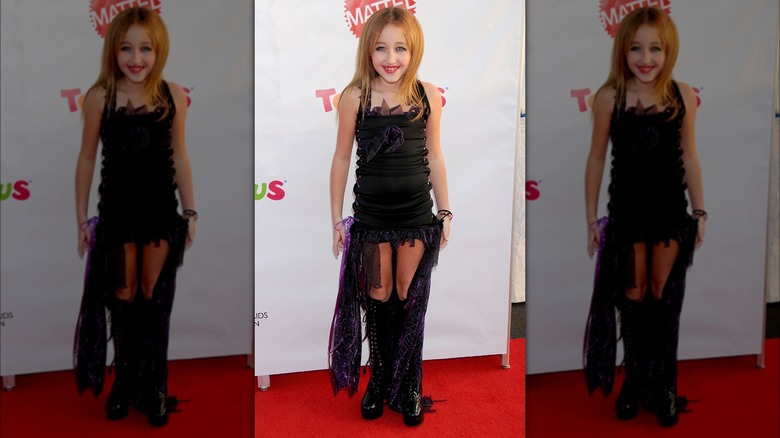 Noah Cyrus wearing a black and purple Halloween costume