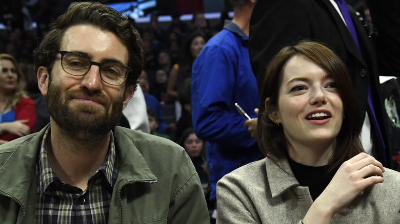 Dave McCary and Emma Stone at a basketball game