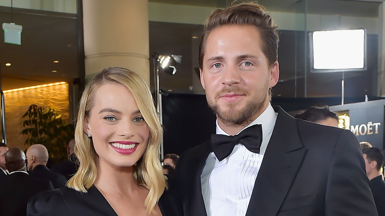 Margot Robbie and Tom Ackerley on a red carpet