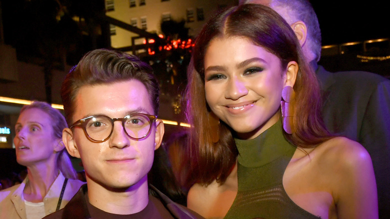 Tom Holland with his arm around Zendaya