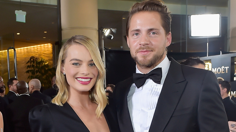 Margot Robbie smiling with Tom Ackerley