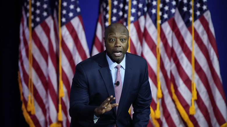 Tim Scott in front of US flags