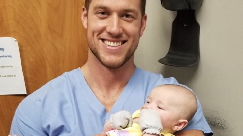 Clayton Echard holding a baby