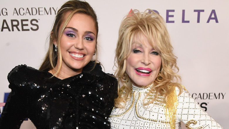 Miley Cyrus and Dolly Parton smiling