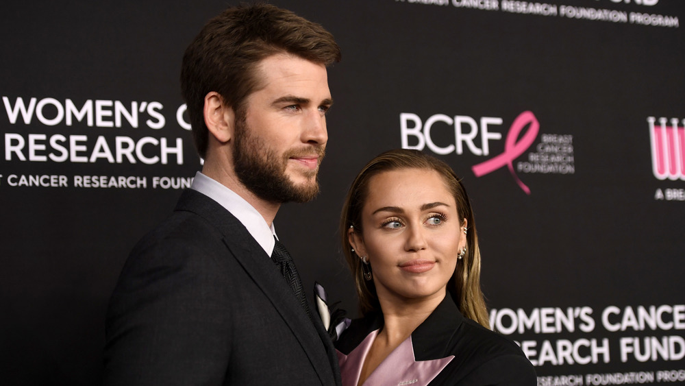 Liam Hemsworth and Miley Cyrus pose on the red carpet