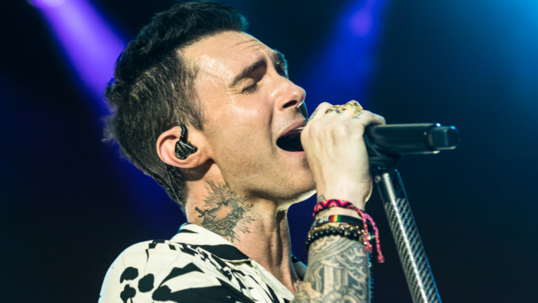 Adam Levine performs on stage