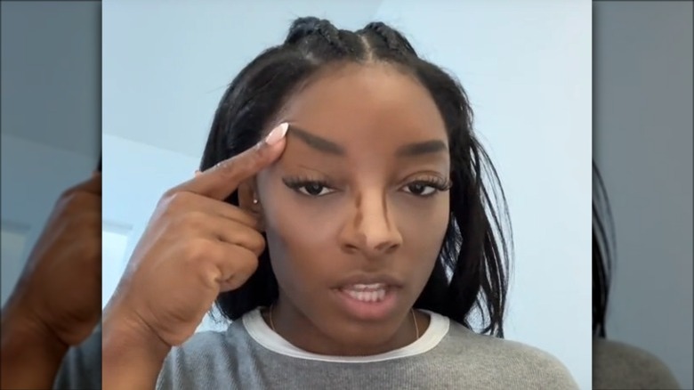 Simone Biles lifts eyebrow with finger