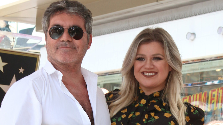 Simon Cowell and Kelly Clarkson pose 