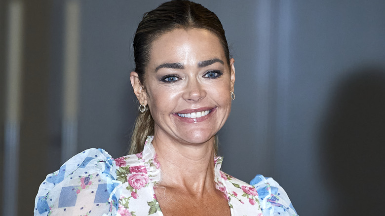 Denise Richards smiles in ruffles