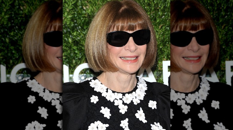 Anna Wintour smiling in a black dress 