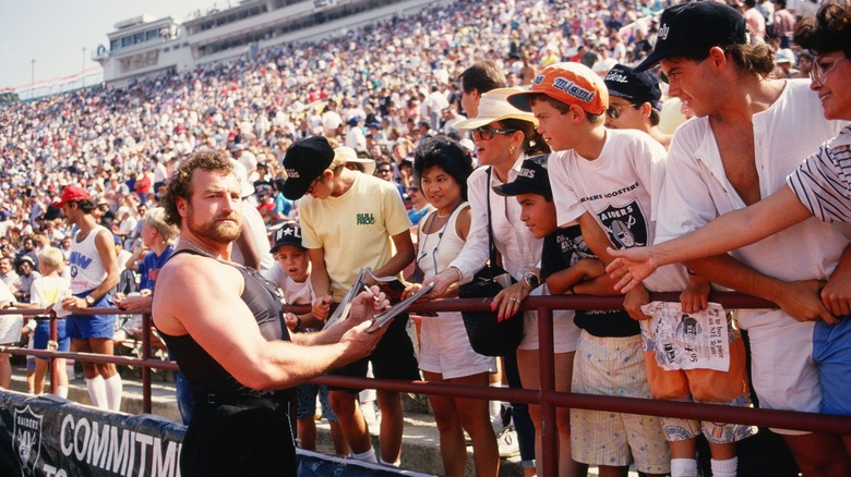 John Matuszak signs autographs.