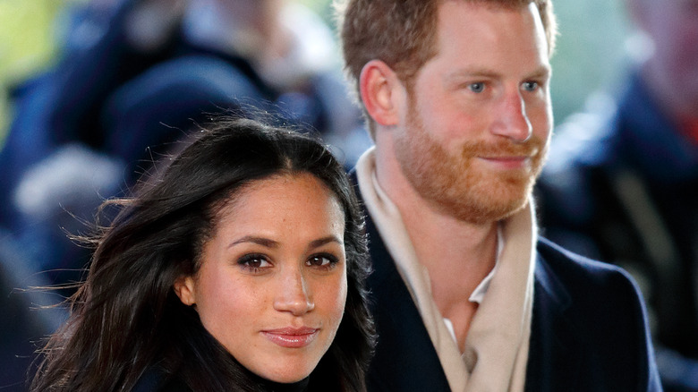 Meghan Markle and Prince Harry walk in the wind