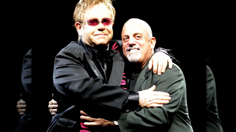 Elton John and Billy Joel hugging