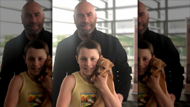 John Travolta and son hold puppy