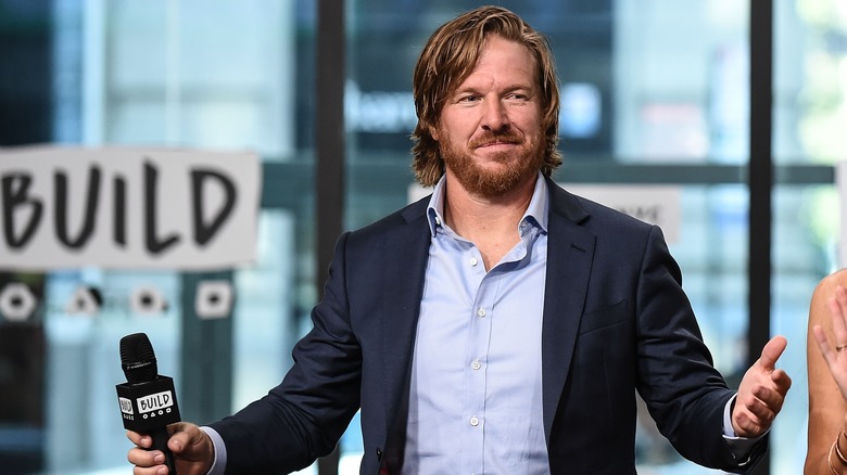 Chip Gaines with arms outstretched