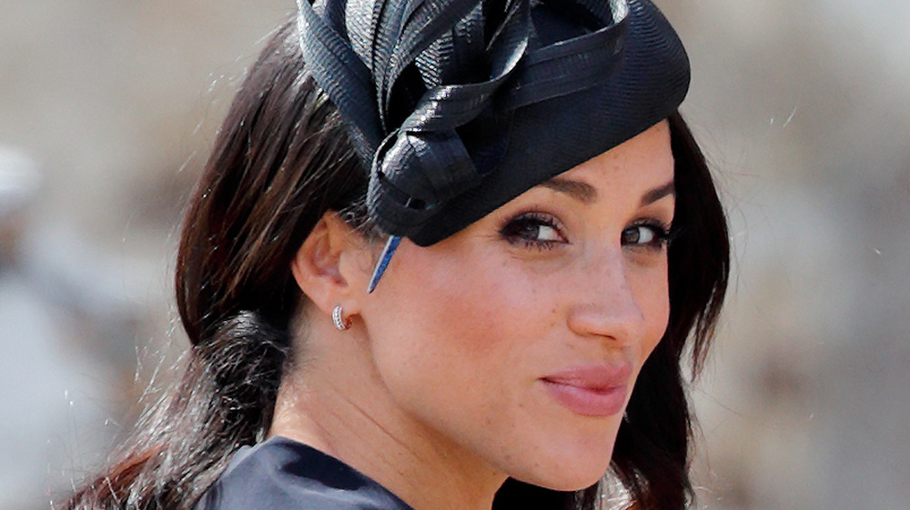 Meghan Markle wearing a black hat