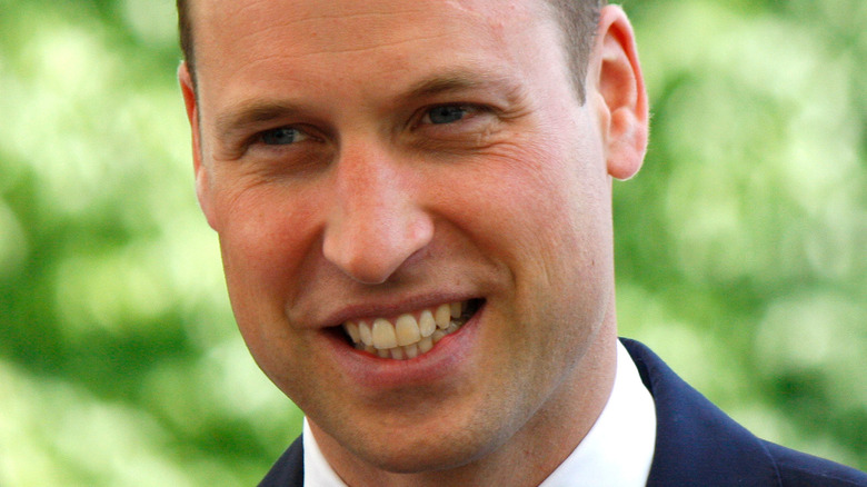 Prince William smiles at an engagement