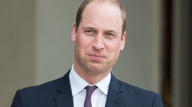 Prince William flashes a wry smile at an engagement