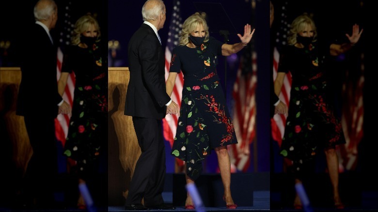 Jill Biden waving, holding President-elect Biden's hand