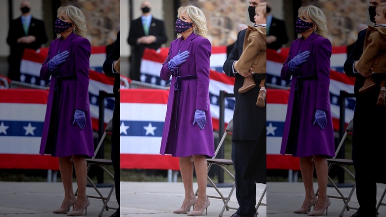 Jill Biden wearing mask with hand on chest 