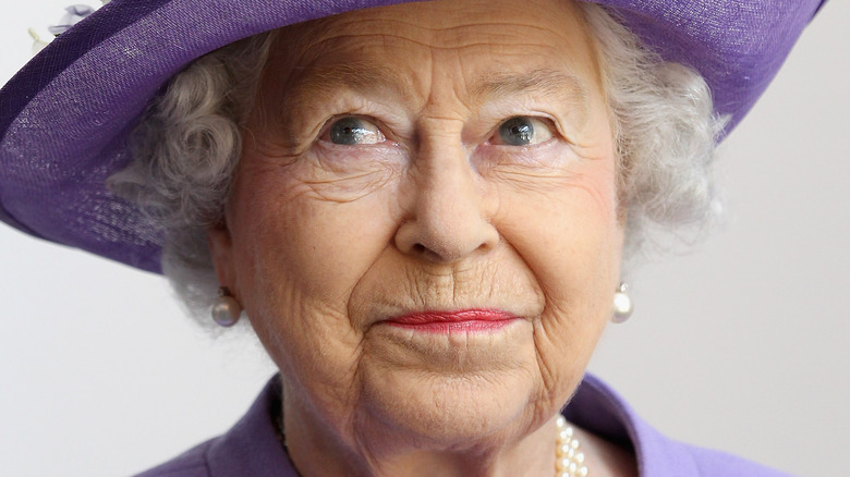 Queen Elizabeth looking cheeky in purple