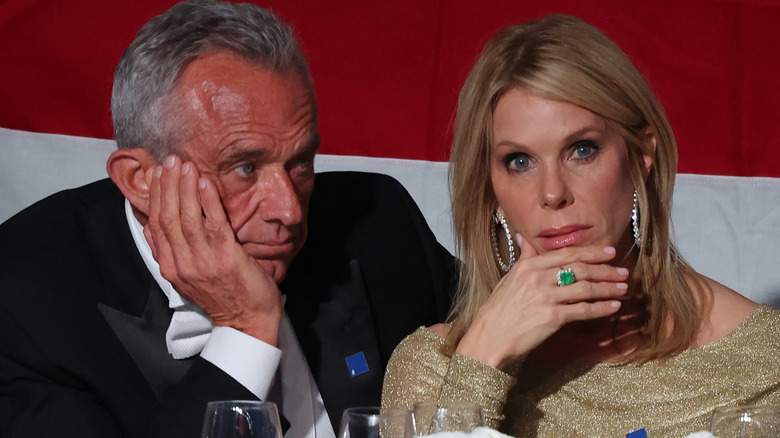 RFK Jr. and Cheryl Hines seating and both touching their faces