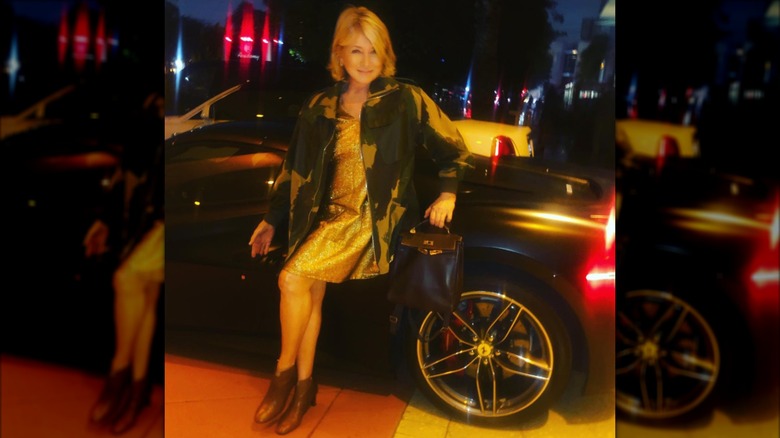 Martha Stewart posing against a Ferrari in a sequin minidress and camo jacket.