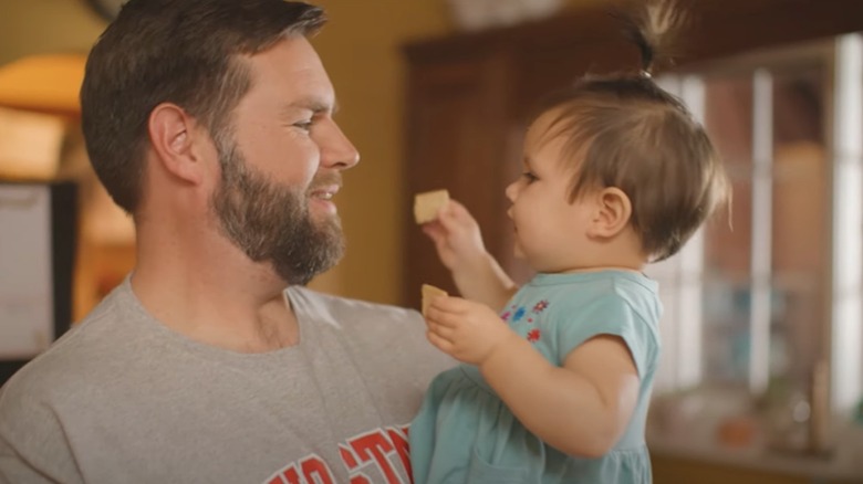 JD Vance holds his daughter in a "JD Vance for Senate" campaign video.