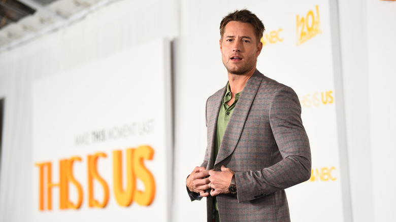 Justin Hartley posing at a "This Is Us" event