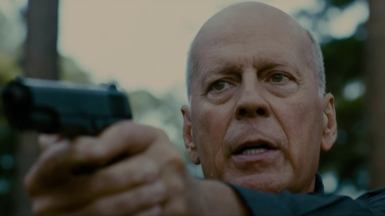 Bruce willis holding gun in american siege 2021