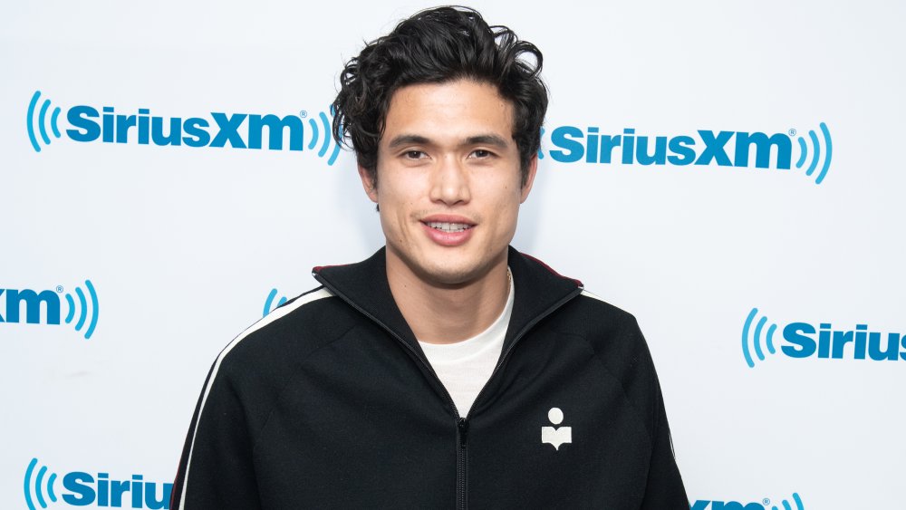 Charles Melton smiling at SiriusXM stuidios