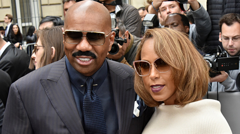 Steve Harvey with spouse Marjorie, posing