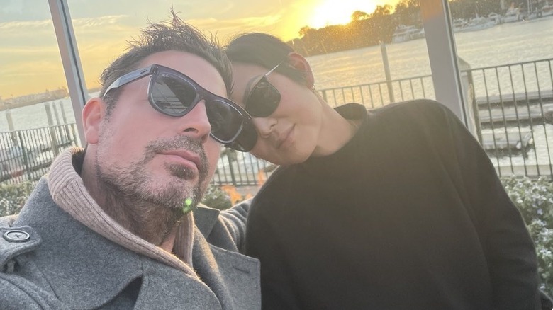 Brennan Elliott and Camilla take a selfie wearing sunglasses.