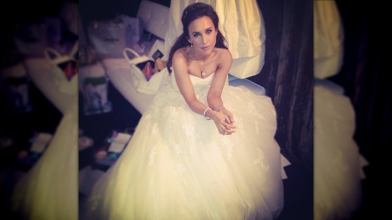 Lacey Chabert sits in her wedding dress.