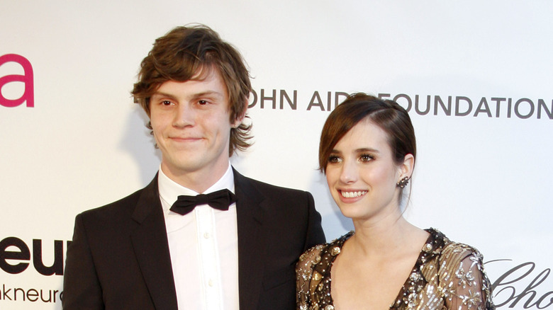 Evan Peters and Emma Roberts smile 