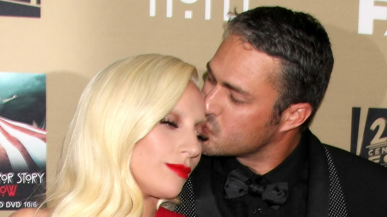 Taylor Kinney kissing Lady Gaga on the red carpet