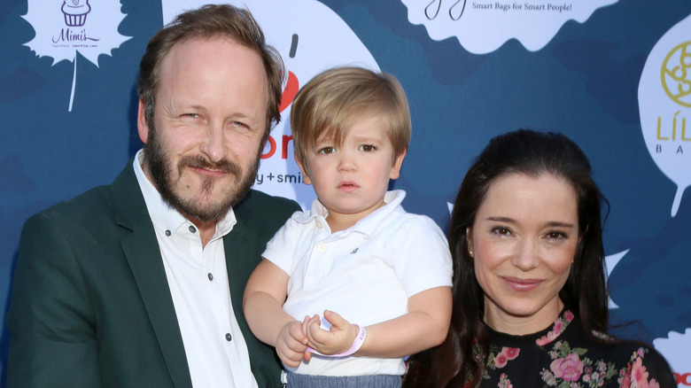 Christopher Redman and Marguerite Moreau posing with son