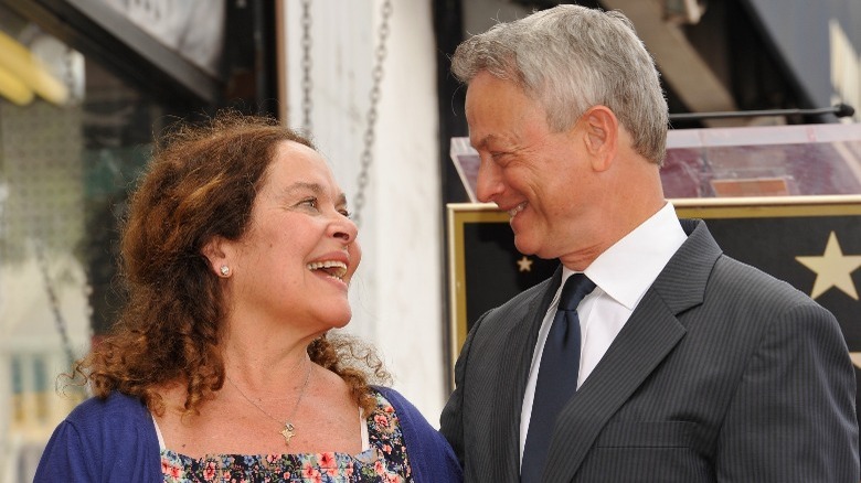 Moira Harris and Gary Sinise smiling at one another