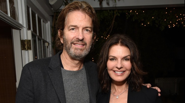 Howard Sherman and Sela Ward, both smiling