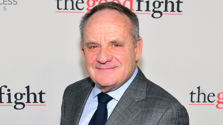 Paul Guilfoyle in a suit and tie