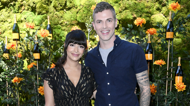 Hannah Simone and Jesse Giddings pose together at a Veuve Clicquot event.