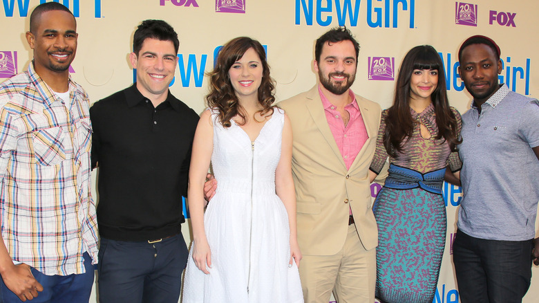 The 'New Girl' cast posing together on the red carpet.