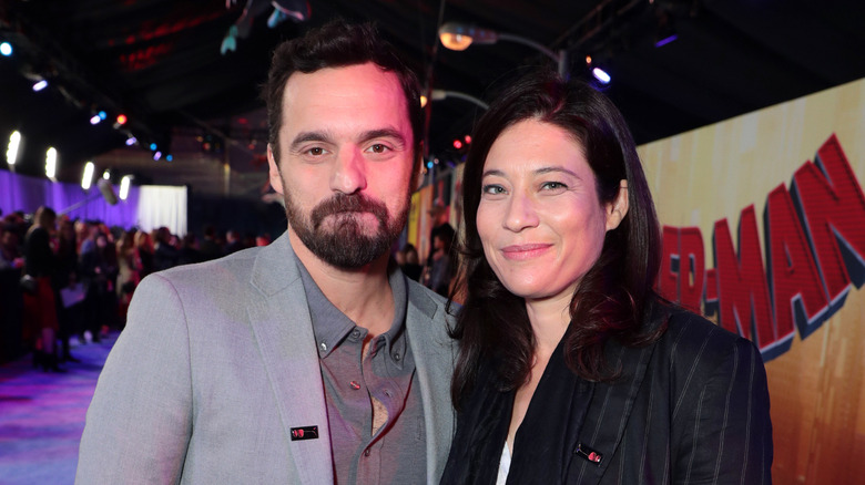 Jake Johnson and Erin Payne posing together at a movie premiere.