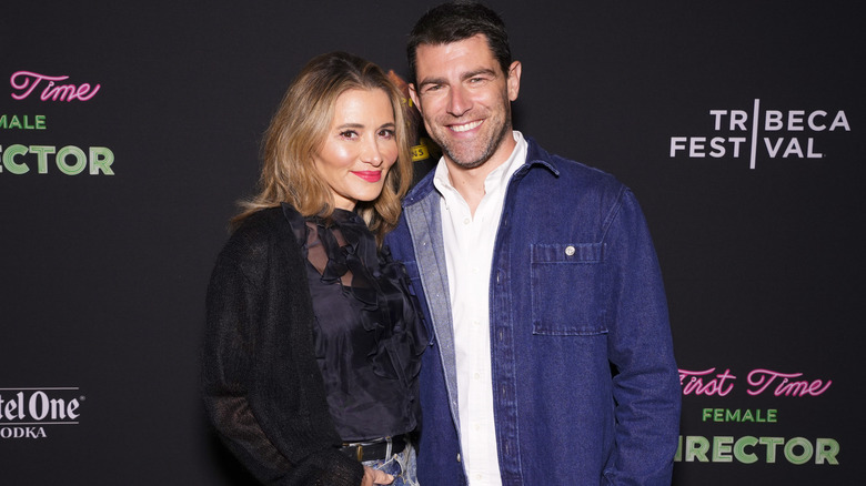 Max Greenfield posing with wife Tess Sanchez.