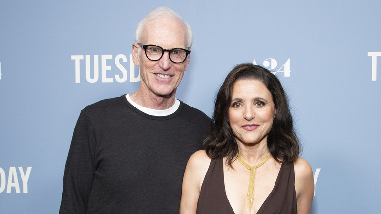 Brad Hall, Julia Louis-Dreyfus with light blue backdrop