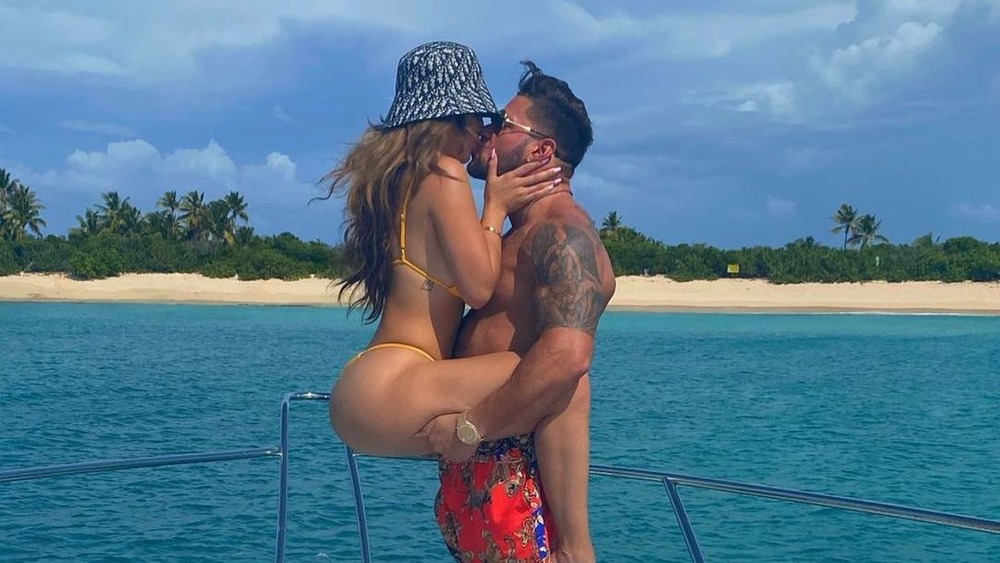 Ronnie Ortiz-Margro and Saffire Matos kissing on a boat