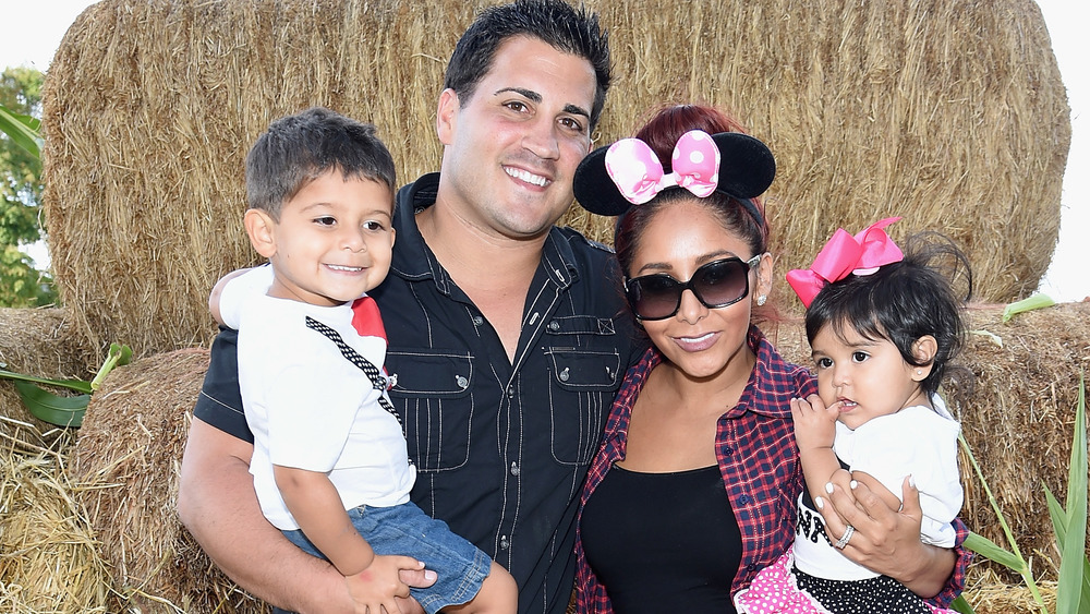 Jionni LaValle, Snooki, and two of their children on a farm