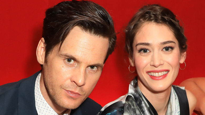 Tom Riley and Lizzy Caplan smiling