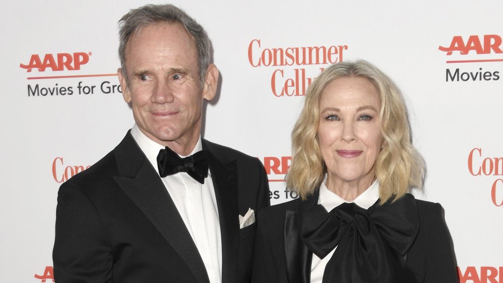 Bo Welch and Catherine O'Hara smiling at an AARP event 