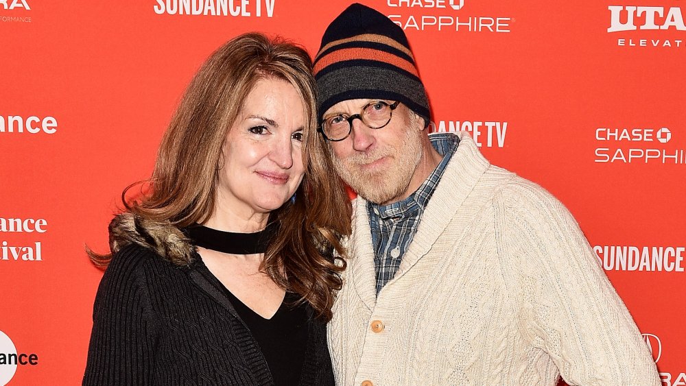 Paula Niedert Elliott and Chris Elliott embracing on a red carpet 